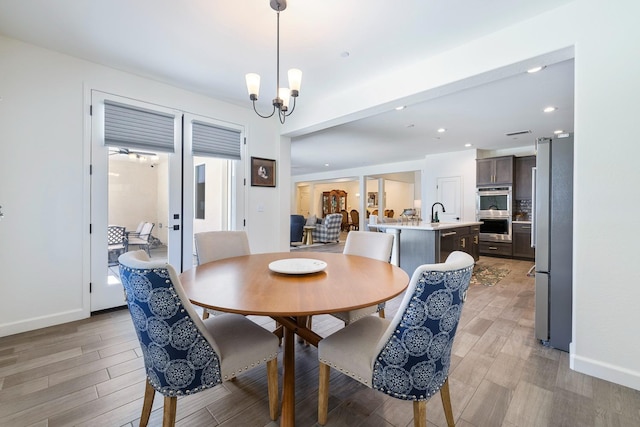 2421 N Cabrenet Pl, Hanford, CA 93230 - dining space featuring light wood-type flooring, a chandelier, and recessed lighting