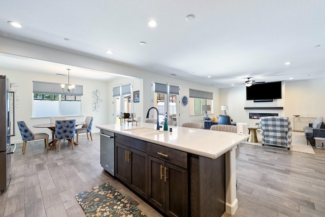 2421 N Cabrenet Pl, Hanford, CA 93230 - kitchen featuring dark brown cabinetry, light countertops, light wood-type flooring, recessed lighting, and ceiling fan