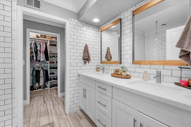 3251 W Magill Ave, Fresno, CA 93711 - full bath with crown molding, double vanity, a spacious closet, tiled shower, and decorative backsplash
