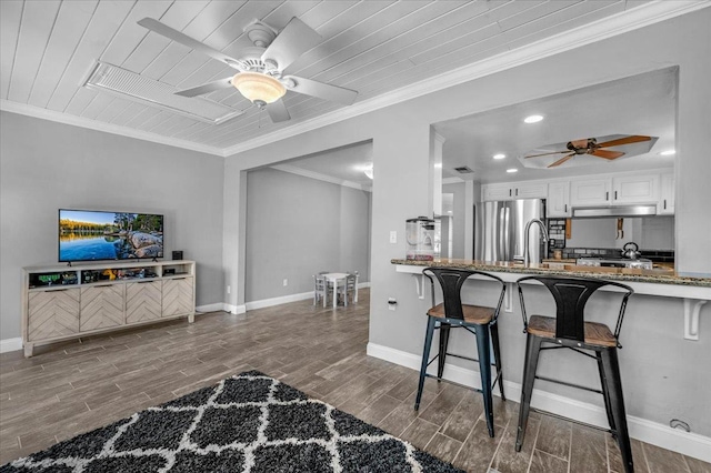 3251 W Magill Ave, Fresno, CA 93711 - kitchen with ceiling fan, freestanding refrigerator, stone countertops, wood finished floors, and a breakfast bar