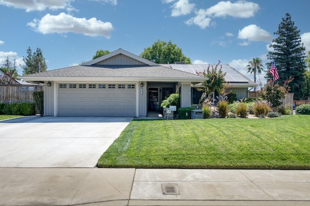 365 Stanford Ave, Clovis, CA 93611 - ranch-style house with roof mounted solar panels, a front yard, driveway, and a garage