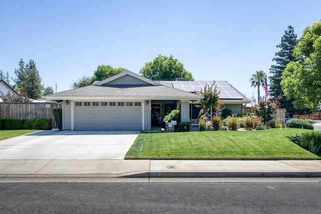 365 Stanford Ave, Clovis, CA 93611 - ranch-style home featuring an attached garage, solar panels, concrete driveway, and board and batten siding