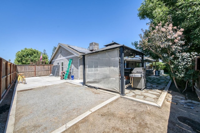 365 Stanford Ave, Clovis, CA 93611 - rear view of property featuring a patio area, a fenced backyard, stucco siding, and solar panels