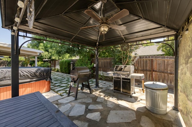 365 Stanford Ave, Clovis, CA 93611 - fenced backyard featuring a hot tub, a gazebo, a patio area, area for grilling, and a ceiling fan