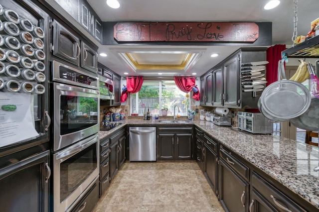 365 Stanford Ave, Clovis, CA 93611 - kitchen with appliances with stainless steel finishes, stone counters, and stone finish floors