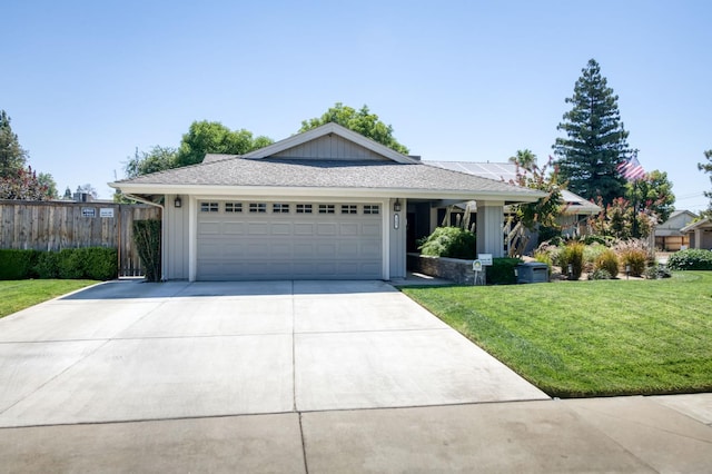 365 Stanford Ave, Clovis, CA 93611 - ranch-style home with board and batten siding, an attached garage, driveway, and solar panels