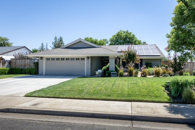 365 Stanford Ave, Clovis, CA 93611 - ranch-style house featuring an attached garage, driveway, and roof mounted solar panels