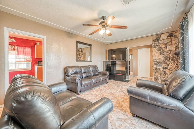 1830 Valeria St, Dos Palos, CA 93620 - living room featuring ceiling fan, a textured ceiling, and light tile patterned flooring