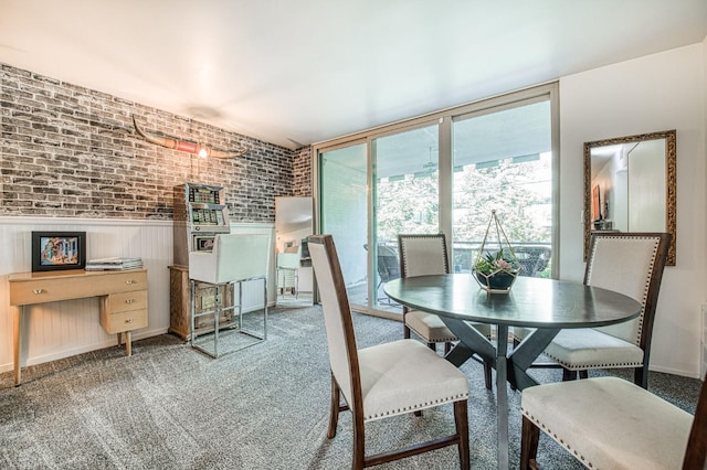 5180 N Wishon Ave Unit 103, Fresno, CA 93704 - carpeted dining area with expansive windows and brick wall