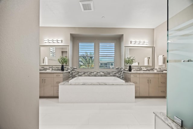 7160 W Dovewood Ln, Fresno, CA 93723 - bathroom featuring a bath, two vanities, backsplash, and tile patterned floors