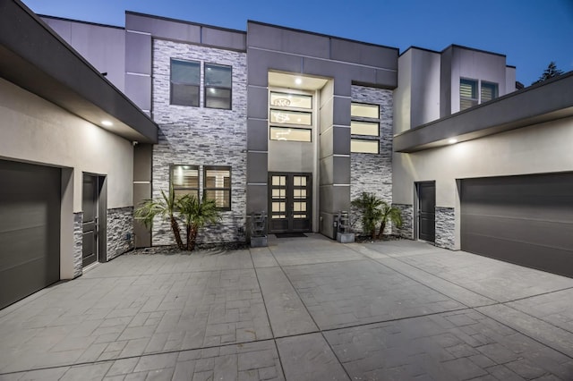 7160 W Dovewood Ln, Fresno, CA 93723 - view of front of house featuring french doors, stone siding, concrete driveway, and stucco siding
