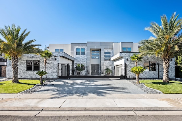 7160 W Dovewood Ln, Fresno, CA 93723 - modern home featuring stone siding and a gate