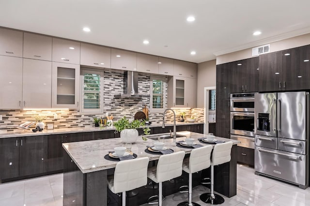 7160 W Dovewood Ln, Fresno, CA 93723 - kitchen featuring appliances with stainless steel finishes, ventilation hood, a warming drawer, modern cabinets, and decorative backsplash