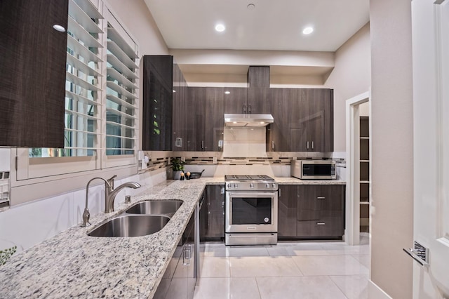 7160 W Dovewood Ln, Fresno, CA 93723 - kitchen with appliances with stainless steel finishes, under cabinet range hood, light tile patterned floors, dark brown cabinetry, and modern cabinets