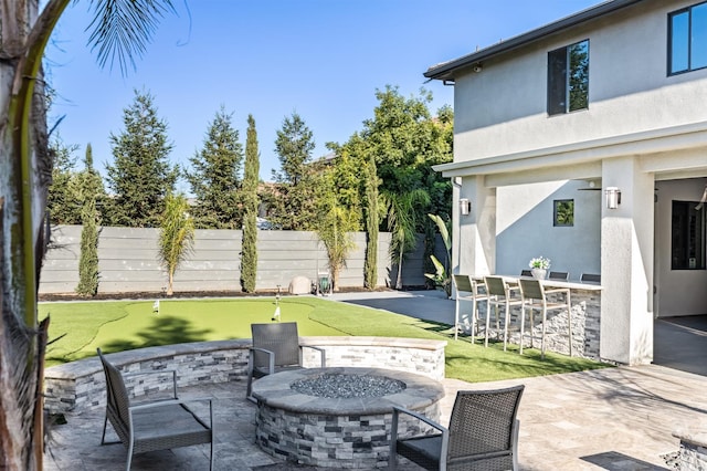7160 W Dovewood Ln, Fresno, CA 93723 - view of patio with a putting area and an outdoor fire pit