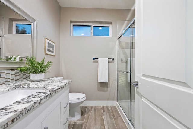 7160 W Dovewood Ln, Fresno, CA 93723 - bathroom featuring vanity, a shower stall, wood finish floors, and healthy amount of natural light