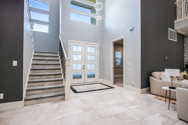 7160 W Dovewood Ln, Fresno, CA 93723 - tiled entryway with stairway, a towering ceiling, and french doors