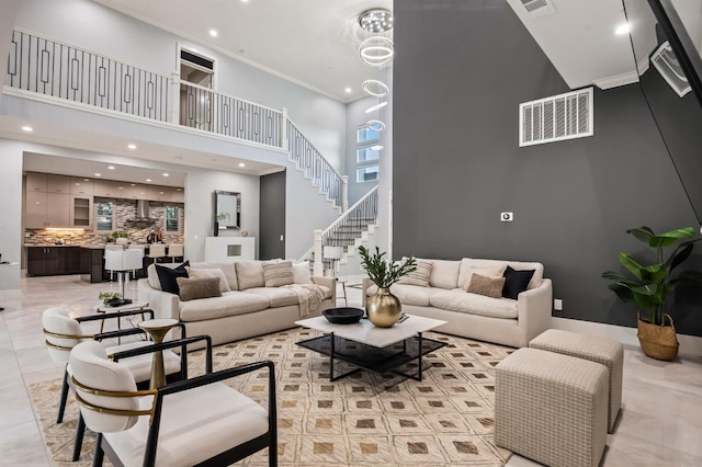 7160 W Dovewood Ln, Fresno, CA 93723 - living room with a towering ceiling, recessed lighting, crown molding, and stairway