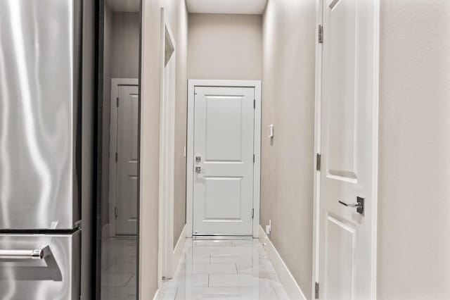 7160 W Dovewood Ln, Fresno, CA 93723 - corridor with baseboards and light marble finish floors