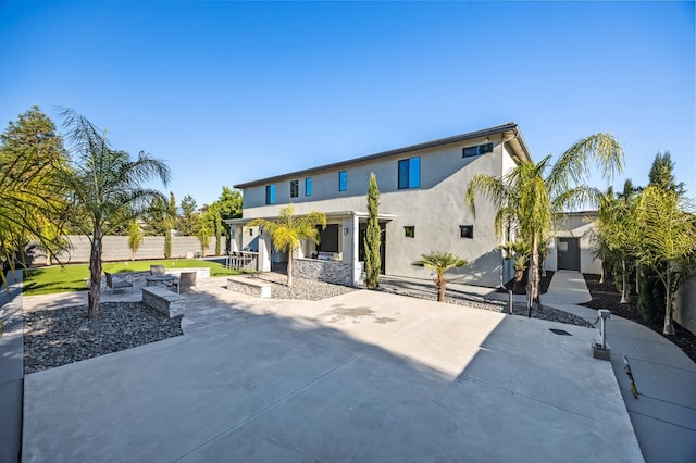 7160 W Dovewood Ln, Fresno, CA 93723 - view of front of property featuring a fire pit, stucco siding, and a patio area
