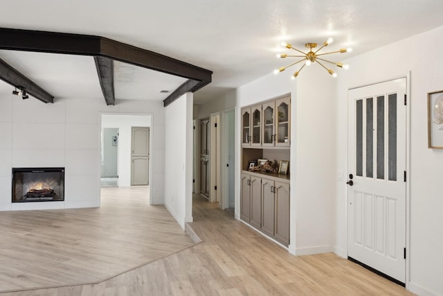 9098 San Gabriel Rd, Atascadero, CA 93422 - unfurnished living room with light wood finished floors, a chandelier, and a fireplace
