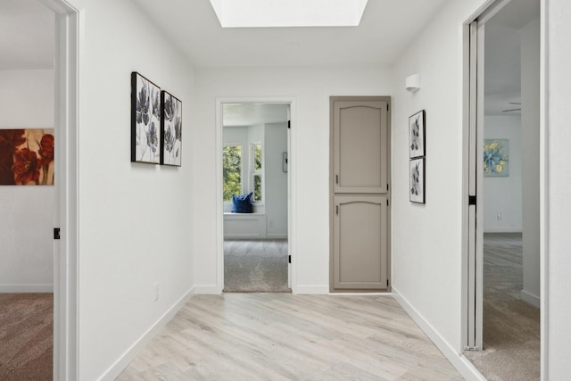 9098 San Gabriel Rd, Atascadero, CA 93422 - corridor with a skylight and light wood-style floors