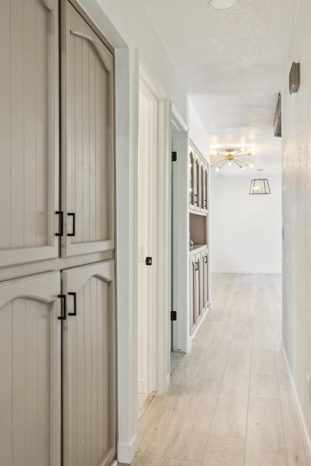 9098 San Gabriel Rd, Atascadero, CA 93422 - hallway featuring a textured ceiling and light wood-style flooring