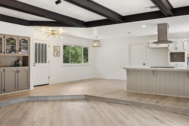 9098 San Gabriel Rd, Atascadero, CA 93422 - unfurnished living room with beamed ceiling, light wood-type flooring, and a chandelier