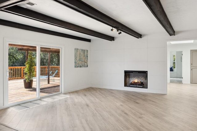 9098 San Gabriel Rd, Atascadero, CA 93422 - unfurnished living room featuring wood finished floors, beam ceiling, and a tiled fireplace
