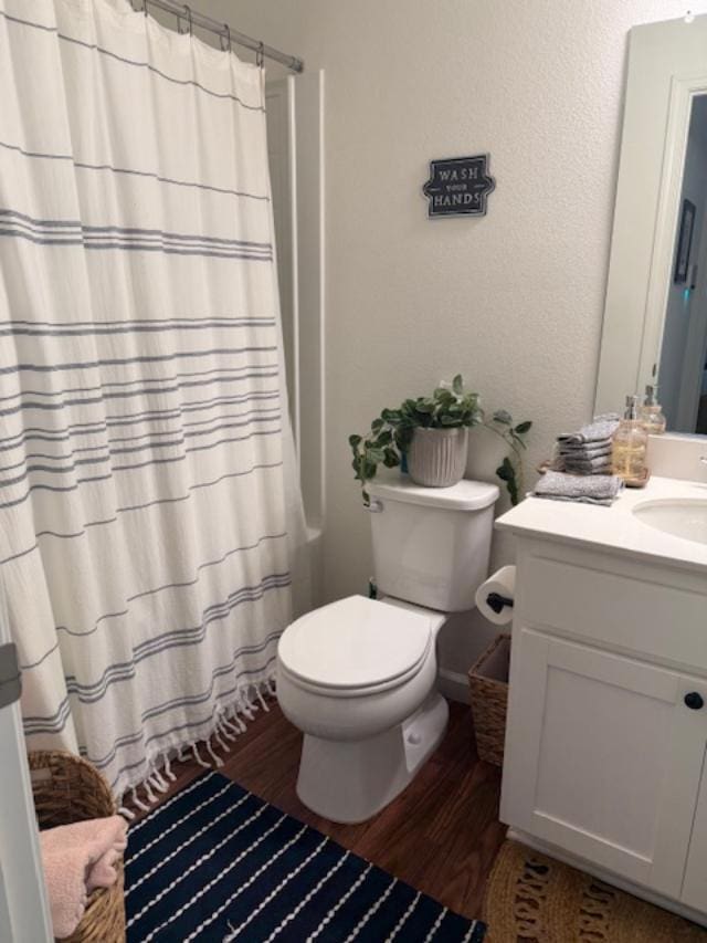 6908 E Castle Ave, Fresno, CA 93727 - full bath with wood finished floors, vanity, and a shower with shower curtain