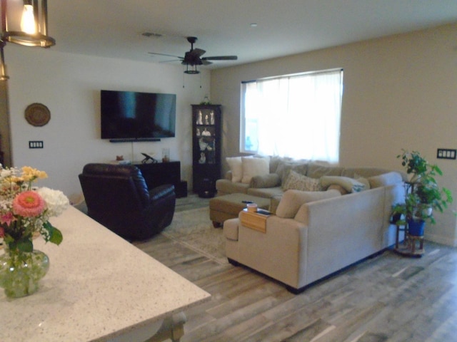 6908 E Castle Ave, Fresno, CA 93727 - living area with light wood-type flooring and a ceiling fan