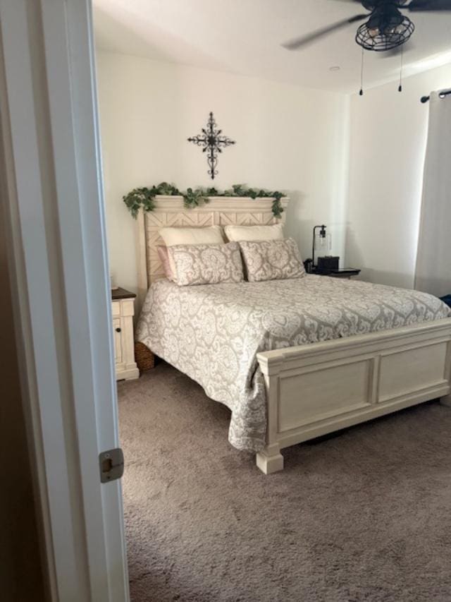 6908 E Castle Ave, Fresno, CA 93727 - bedroom with dark carpet and ceiling fan
