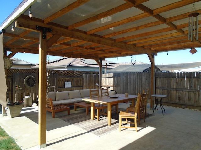 6908 E Castle Ave, Fresno, CA 93727 - fenced backyard with outdoor dining area, a patio area, and an outdoor living space