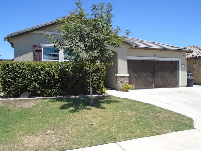 6908 E Castle Ave, Fresno, CA 93727 - view of front of house featuring an attached garage, driveway, a front yard, stucco siding, and a tile roof