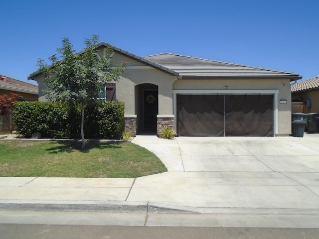6908 E Castle Ave, Fresno, CA 93727 - view of front of house with a garage, stucco siding, concrete driveway, and a tiled roof