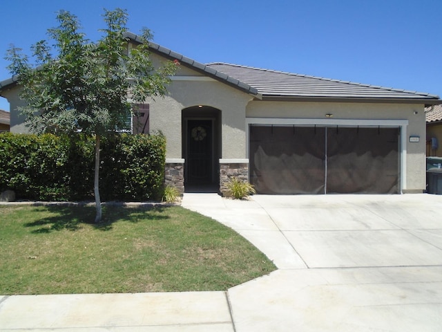 6908 E Castle Ave, Fresno, CA 93727 - view of front of house with a garage, driveway, a tile roof, and stucco siding