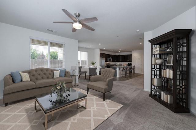 7173 N Shiraz, Fresno, CA 93722 - living area featuring a ceiling fan, light carpet, and recessed lighting