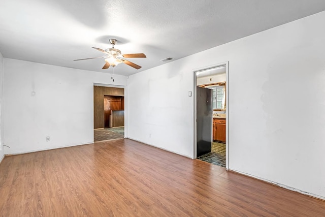 8573 E Ostler St, Selma, CA 93662 - spare room with ceiling fan and wood finished floors