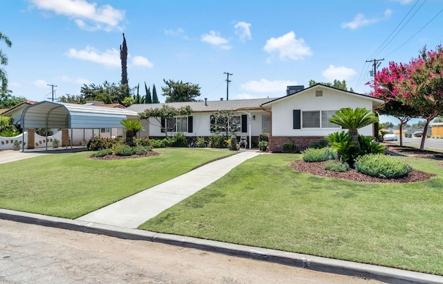8573 E Ostler St, Selma, CA 93662 - ranch-style house with a detached carport, a front yard, brick siding, and stucco siding
