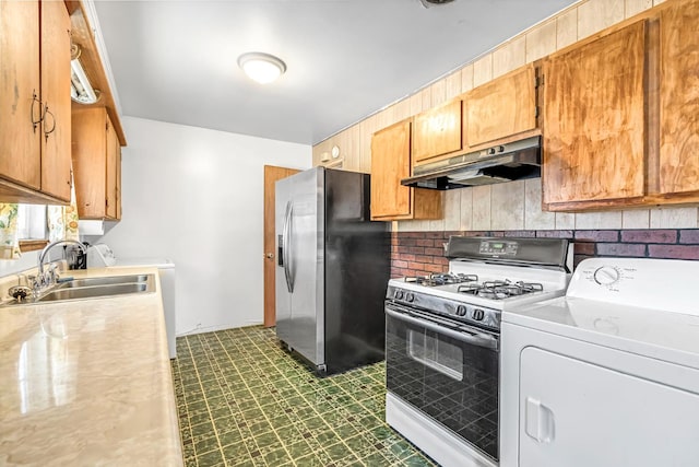 8573 E Ostler St, Selma, CA 93662 - kitchen featuring washer / clothes dryer, under cabinet range hood, white gas stove, and stainless steel fridge