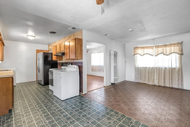 8573 E Ostler St, Selma, CA 93662 - kitchen with freestanding refrigerator, a heating unit, range, and washer / clothes dryer