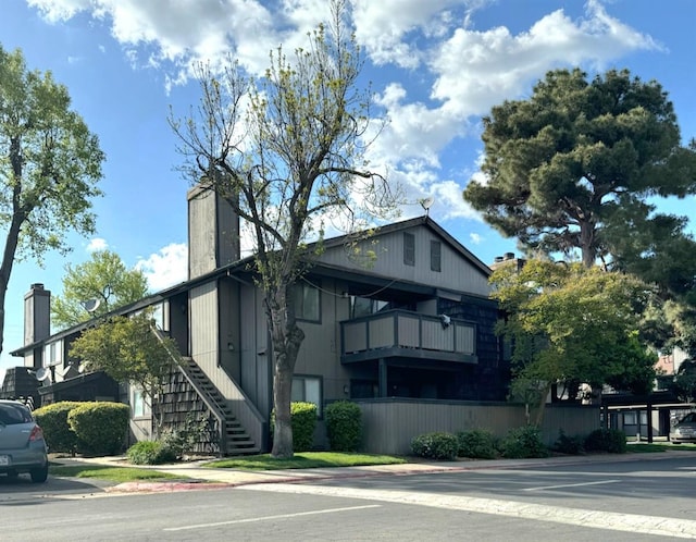 1151 S Chestnut Ave Unit 108, Fresno, CA 93702 - view of side of home with a chimney, stairway, and a balcony