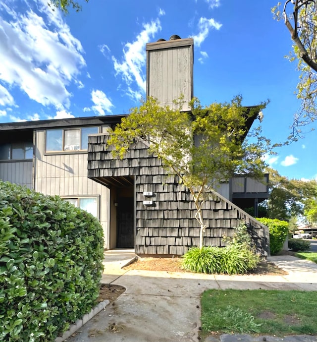 1151 S Chestnut Ave Unit 108, Fresno, CA 93702 - view of front facade with a chimney and stairs