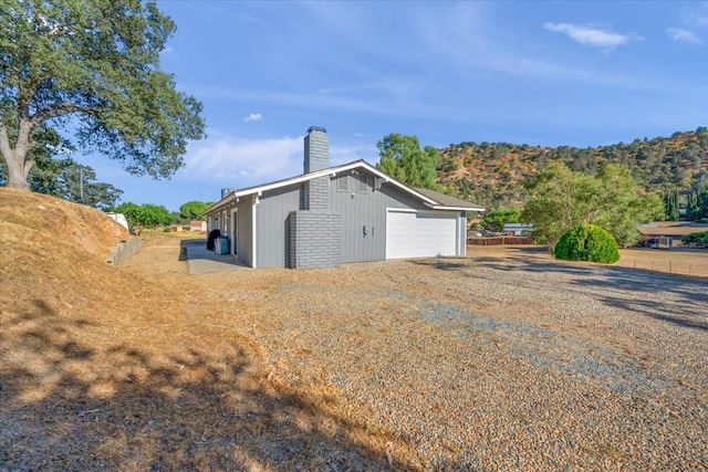 27762 Twin Ponds Rd, Clovis, CA 93619 - view of home's exterior featuring a chimney and a detached garage