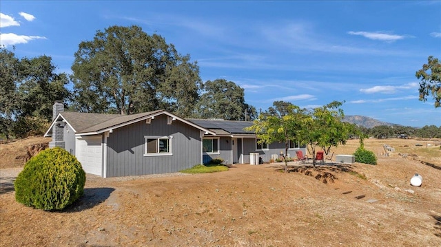 27762 Twin Ponds Rd, Clovis, CA 93619 - view of front of house with a chimney, solar panels, and an attached garage