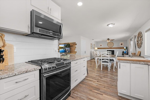 27762 Twin Ponds Rd, Clovis, CA 93619 - kitchen with appliances with stainless steel finishes, a ceiling fan, light wood-style floors, white cabinets, and recessed lighting