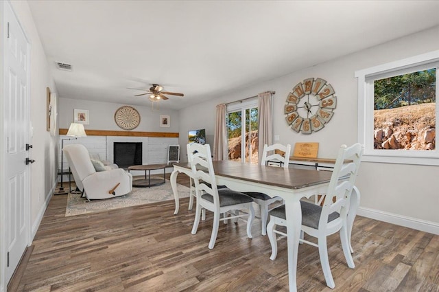 27762 Twin Ponds Rd, Clovis, CA 93619 - dining room featuring a ceiling fan, wood finished floors, and a fireplace