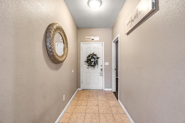 3615 W Michigan Ave, Fresno, CA 93722 - entryway featuring light tile patterned flooring and baseboards