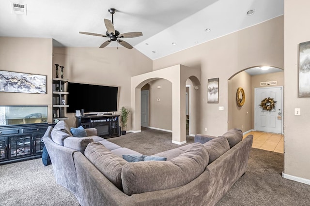 3615 W Michigan Ave, Fresno, CA 93722 - living room with carpet, arched walkways, a ceiling fan, and high vaulted ceiling