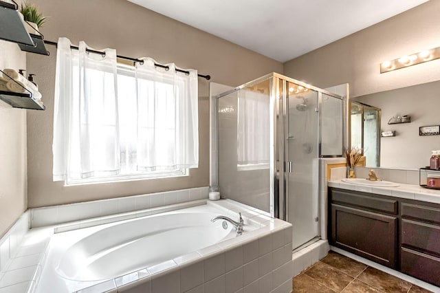 3615 W Michigan Ave, Fresno, CA 93722 - bathroom with a stall shower, a bath, vanity, and tile patterned floors